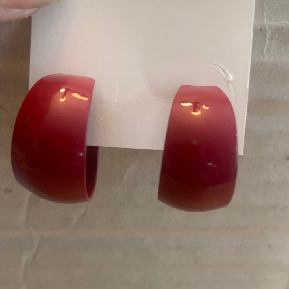 Dark pink open hoop metal earrings.
